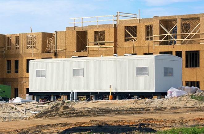 crane lifting modular building for construction office rentals in Clarkdale